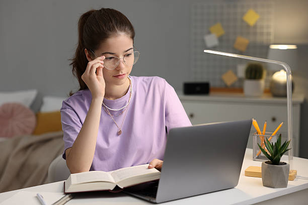 istock Student preparing for exam with laptop at table indoors 2224067350
