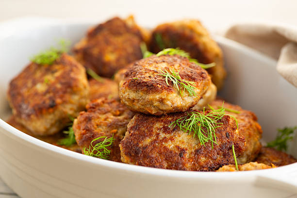 istock Delicious fried cutlets in a baking dish on a white table 2224067755