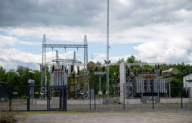 istock Electric power substation with transformers and high-voltage equipment outdoors on cloudy day 2224069870