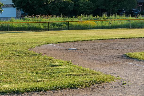 istock a close up of third base on diamond two in the park at dawn 2224070007