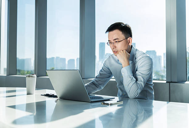 istock Businessman using laptop by the window 2224070741