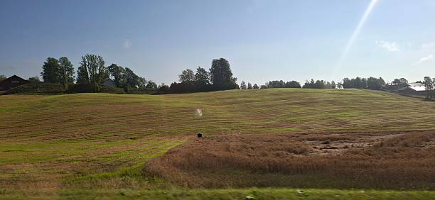 istock Norway Klofta Serene Countryside Landscape with Rolling Green Fields Beneath Clear Skies 2224071693