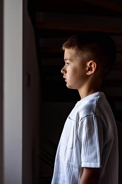 istock Side Profile of a Thoughtful Young Boy in Natural Lighting 2224072631