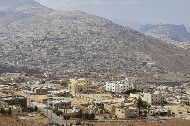 Wide view of Wadi Musa, the modern town serving as a gateway to Petra, Jordan, with clustered houses on arid hillsides