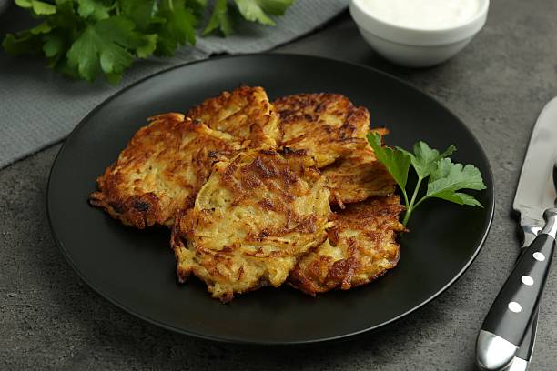 istock Delicious potato pancakes served on grey table, closeup 2224076678