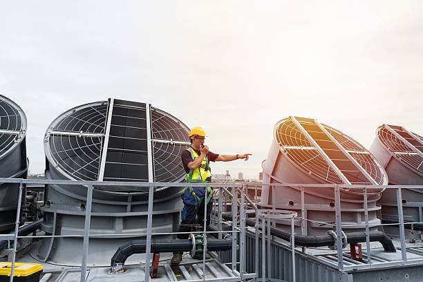 istock Cooling tower operations, Legionnaires disease prevention.
Engineer or technicians maintenance and repair of cooling towers for preventing issues Legionella growth on rooftop of building 2224078025