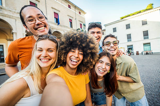 istock Multicultural cheerful friends taking selfie pic with smart mobile phone device - Youth community people laughing at camera together - Friendship concept with guys and girls having fun outdoors 2224079880