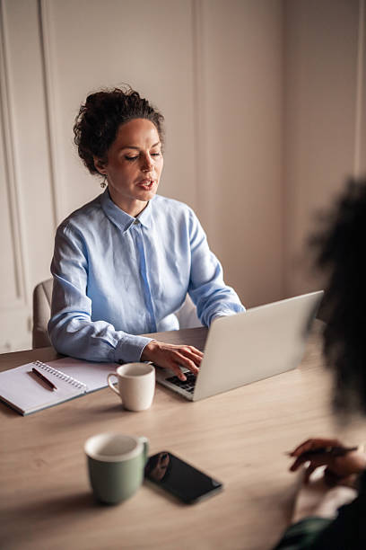 istock Professional Woman at Work Using a Laptop in an Office Environment 2224081558