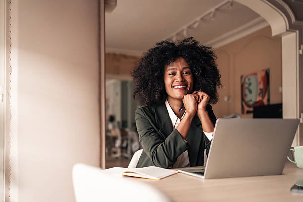 istock Confident Businesswoman Working at Laptop in Modern Office Setting 2224081592