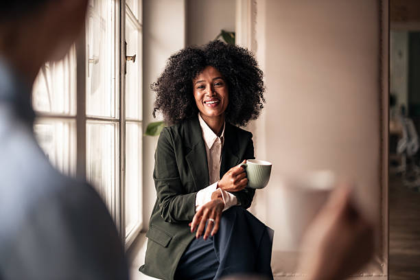istock Smiling Woman Engages in Friendly Conversation Over Coffee Indoors 2224081674