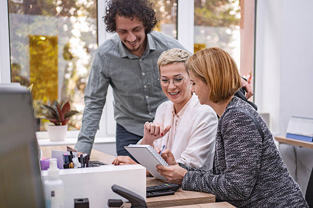 istock Business team collaborating on a project, reviewing notes and smiling in the office 2224083020