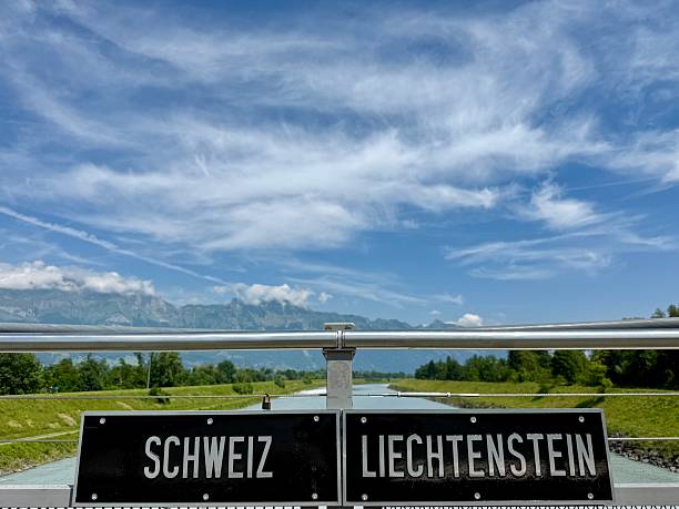 Border sign Switzerland-Liechtenstein with river Rhine in background