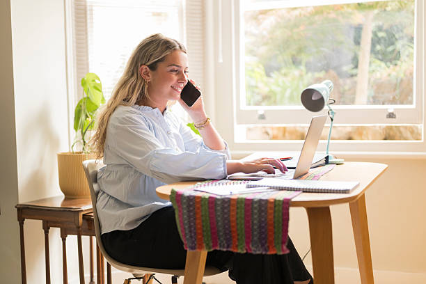 istock Young woman working remotely from home office 2224086134