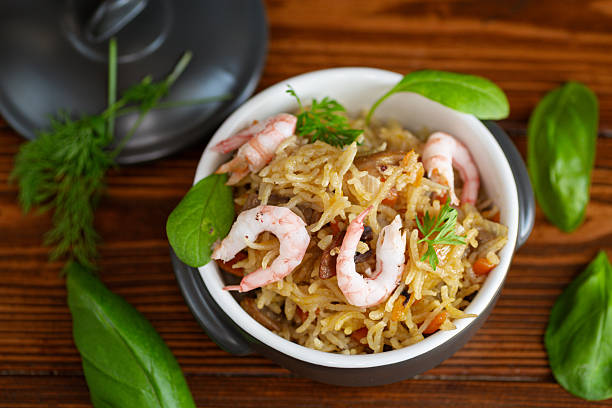 A detailed close-up of Thai-style fried rice featuring golden scrambled eggs, tender chicken, and fresh vegetables. The dish showcases a delightful combination of textures, from the crispy bits of egg to the soft, fluffy rice. Garnished with diced red chilies, it reflects the rich and bold flavors of traditional Thai cuisine. This appetizing meal is a staple of Asian street food and home-cooked comfort food, making it perfect for food photography, menu design, and culinary inspiration.