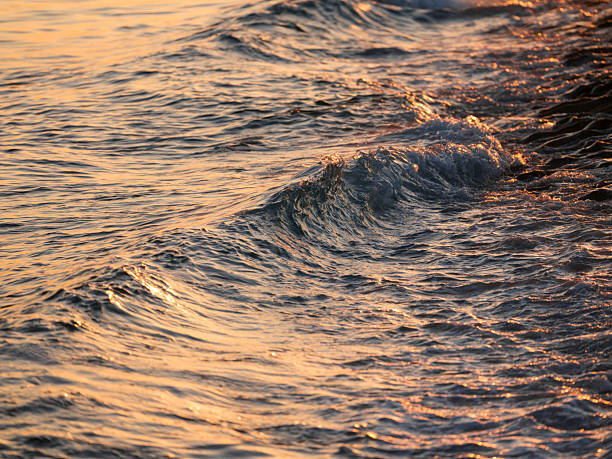 istock beautiful sea waves at sunset 2224087096