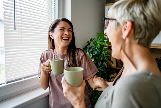 istock Mother and daughter sharing a laugh over coffee at home 2224087285