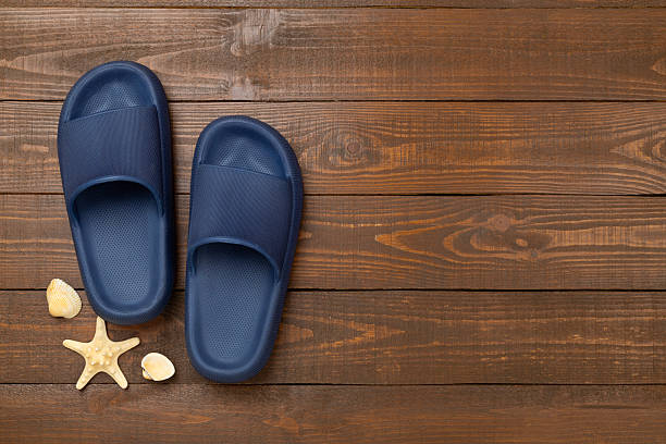 istock Blue sandals on wooden background,top view 2224089547