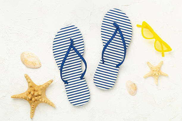 istock Striped blue flip flops on concrete background, top view 2224089558