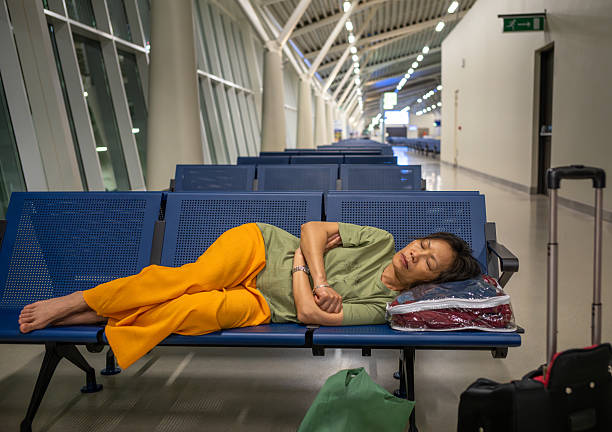 A female passenger sleeps before her flight in Julius Nyerere International Airport Terminal 3, Dar es Salaam, Tanzania