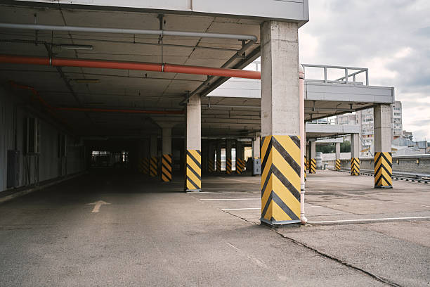 istock Empty Parking Lot. Underground parking. Empty Parking Garage. Empty shopping mall underground parking lot or garage interior with concrete stripe painted columns. 2224091804