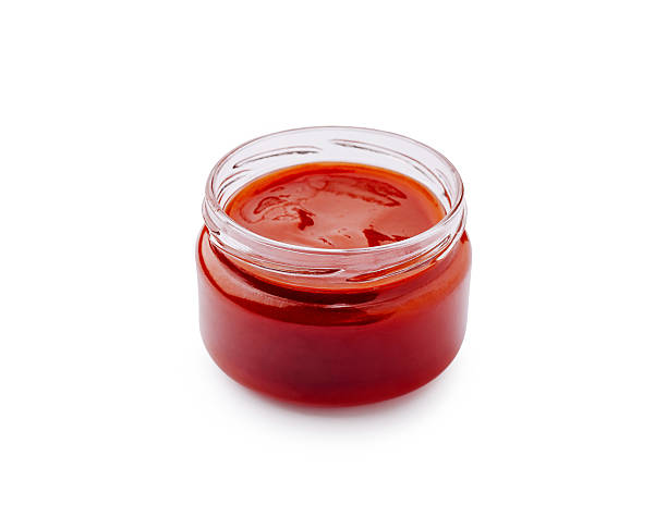 istock Delicious red sauce in a glass jar on a plain surface 2224093336