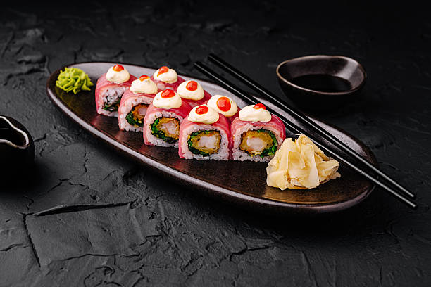 istock Delicious sushi rolls served on a dark plate with wasabi and ginger 2224094853