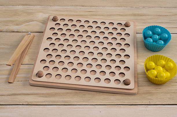istock Wooden sorting board - games with colorful balls. The game is Montessori system. 2224094886