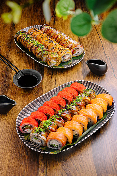 istock Sushi rolls display beautifully arranged on plates in a warm setting 2224094964
