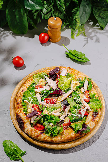 istock Fresh salad pizza topped with chicken, vegetables, and herbs 2224095005
