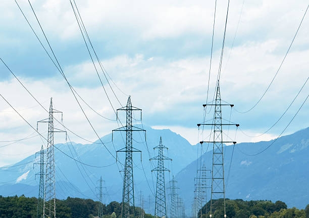 istock Transmission towers against mountainous backdrop on cloudy day 2224096250