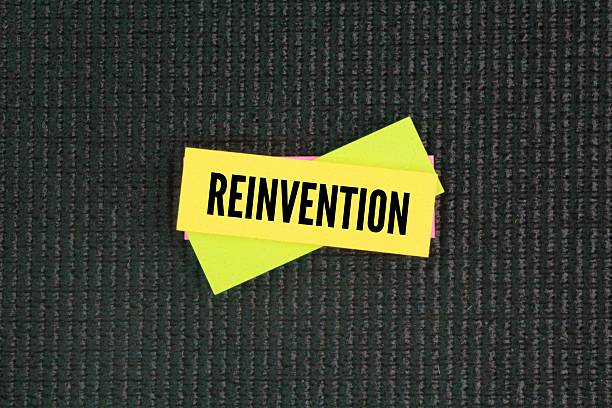 istock colored paper with the word Reinvention. the action or process through which something is changed so much that it appears to be entirely new. 2224098290