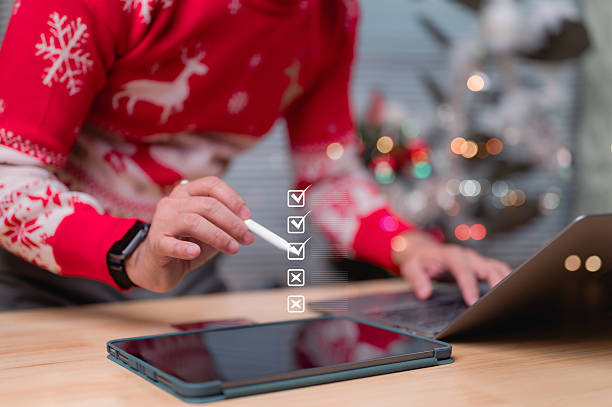 Productive Festive Christmas Work White Stylus Guides Digital List On Tablet, Set Against Light Wooden Desk With Blurred Background Of Warm Lights, Embodying Holiday Organization