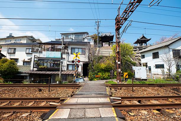 istock Japanese railway crossing with traditional buildings. 2224101742