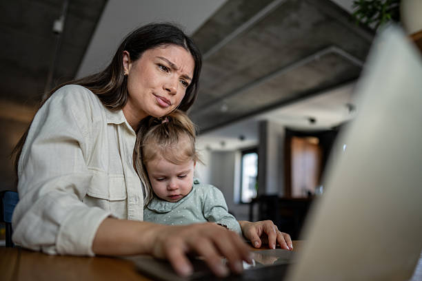 istock Focused mother working from home with child 2224102167