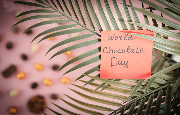 istock Paper note world chocolate day in palm tree branches. 2224102466