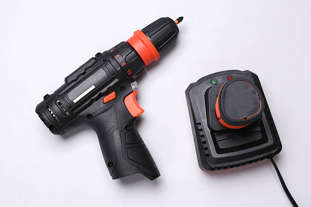 istock Modern cordless screwdriver with charger on white background. Top view 2224102937