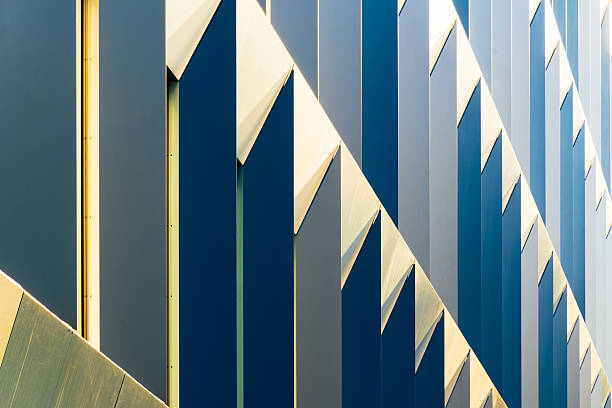 istock Abstract Modern Facade with Geometric Patterns, Blue and Yellow Panels, and Sunlight Reflections 2224104407