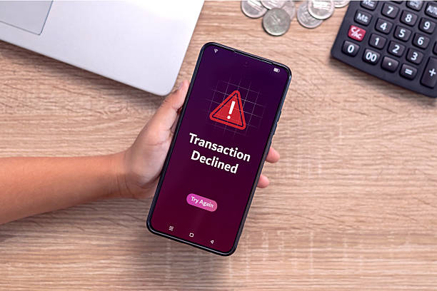 istock Hand holding smartphone with declined transaction notification on screen. Payment failed or declined. 2224104900