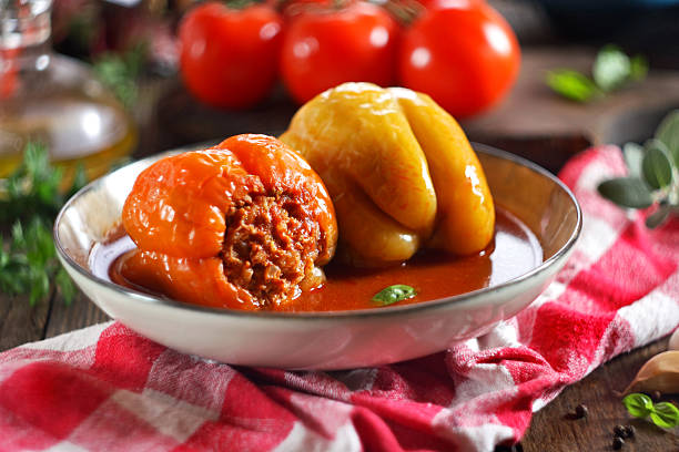 Preparing Stuffed Peppers with Ground Beef, Rice, Tomato Sauce and Parmesan Cheese