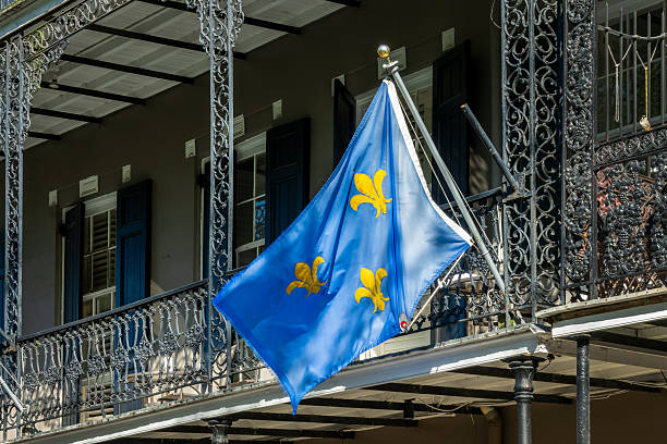 istock NOLA flag with gold Fleur-de-Lis and architecture with balconies and columns adorned with ironwork in the French Quarter, New Orleans, Louisiana 2224107191