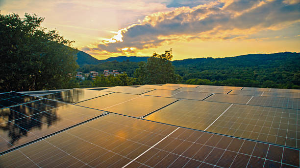 istock Modern Solar Power Panels on House Rooftop at Sunset with Scenic Mountain View 2224108139