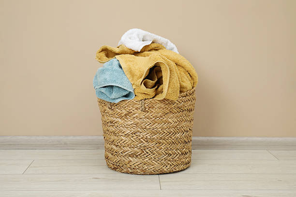 istock Wicker basket full of laundry on floor indoors 2224109292