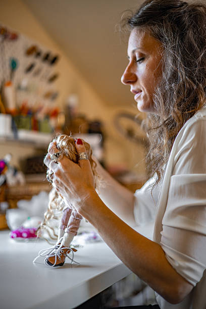 istock Independent designer passionately handcrafting unique fabric characters in a snug home-based workspace, building her creative brand through personalized toy orders 2224109701