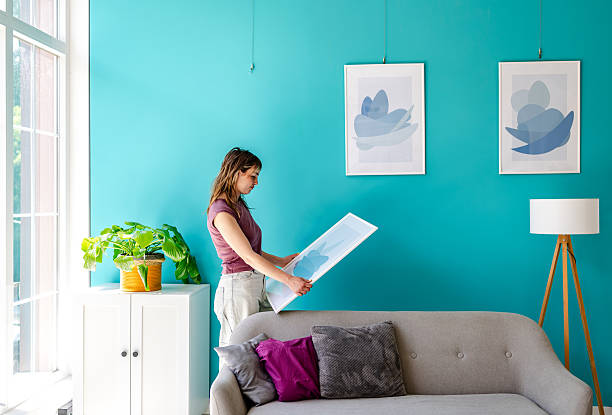 istock Confused woman decorating apartment 2224110286