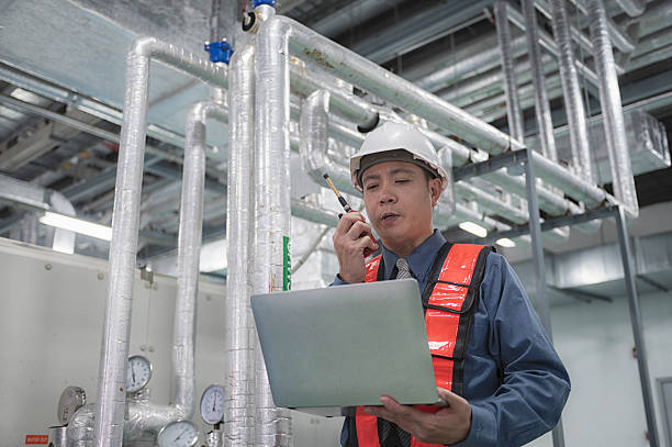 istock People  working on Air condition plant 2224110504
