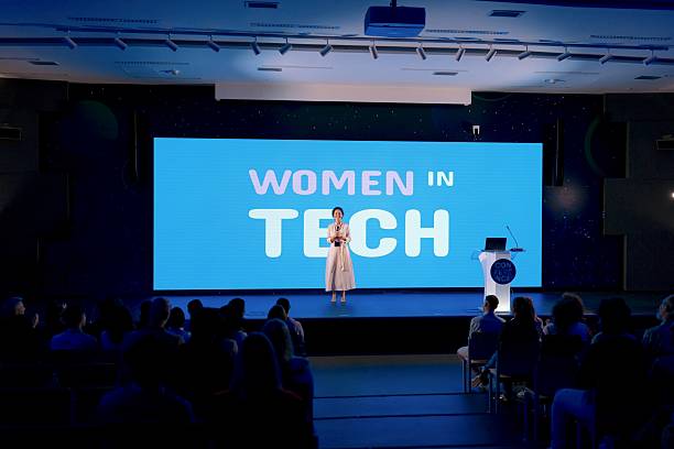 istock Confident Speaker Presenting at Women in Technology Conference in Modern Venue 2224110606