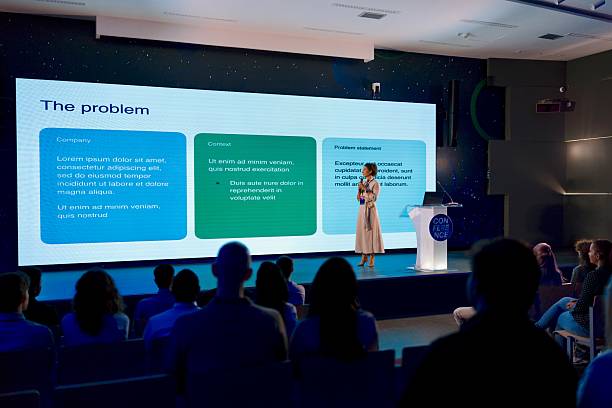 istock Confident Woman Speaking at a Technology Conference with Audience Engagement 2224110628