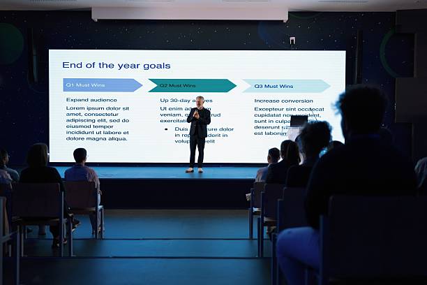 Speaker presenting strategy insights to an attentive audience at a corporate event.