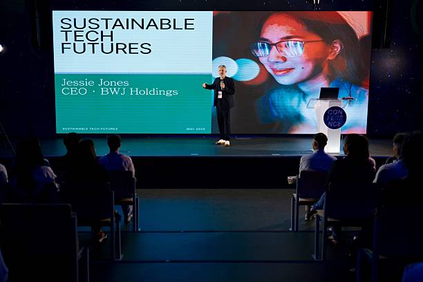 istock Keynote Speaker on Sustainable Technology at Modern Tech Conference with Presentation Backdrop 2224110720