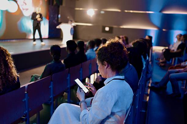 istock Audience Watching Speaker at Professional Conference in Modern Venue 2224110724